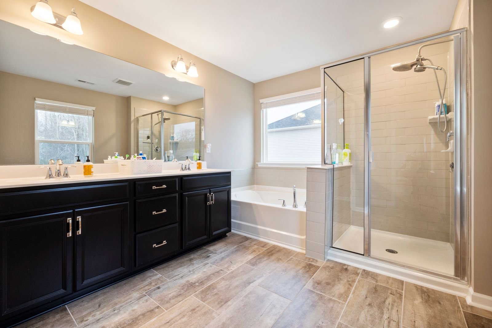 Bathroom with double vanity, tub and glass shower