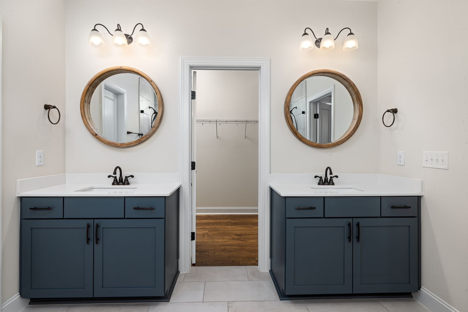 Bathroom vanity with dual sinks and round mirrors