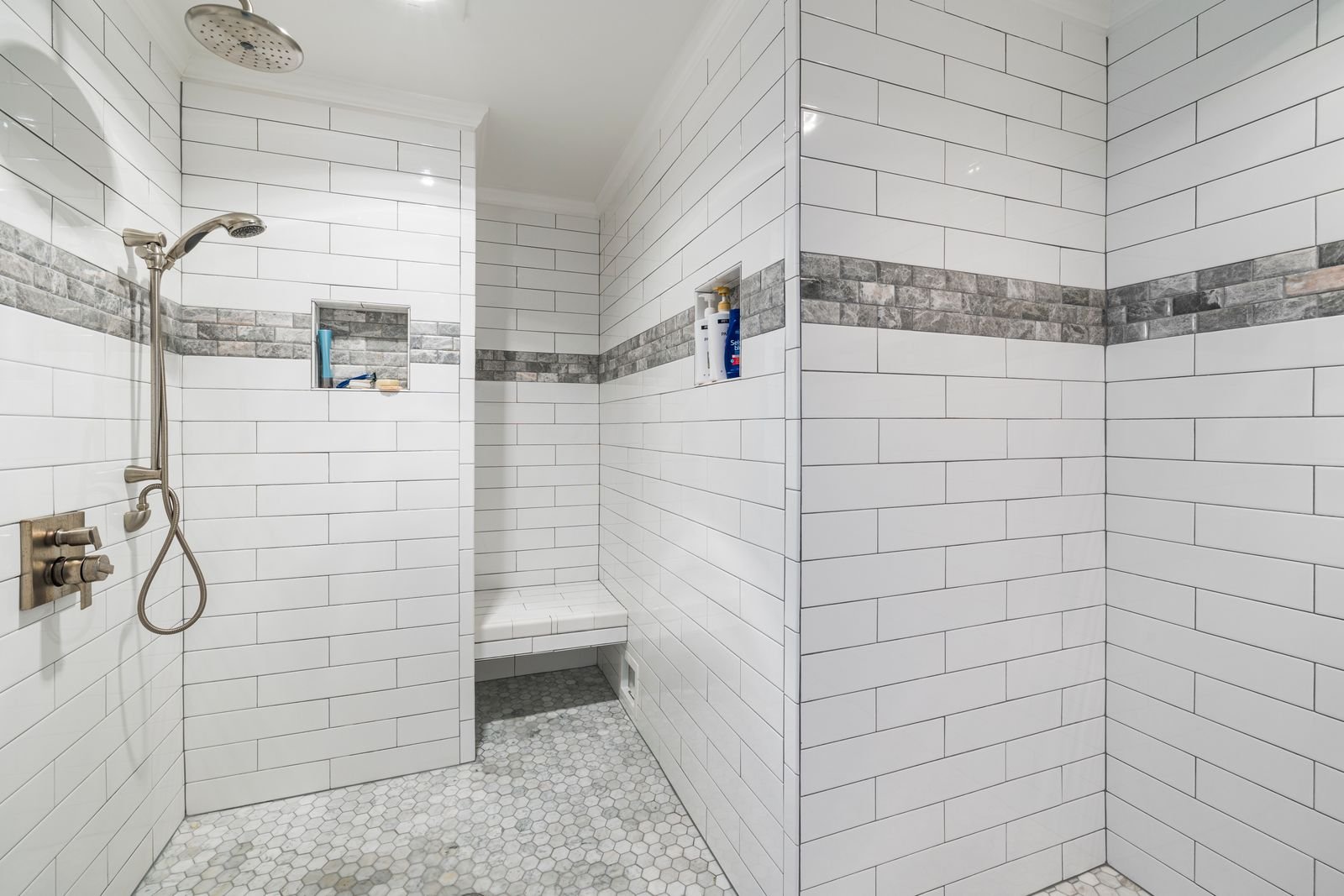 White tiled shower with modern fixtures